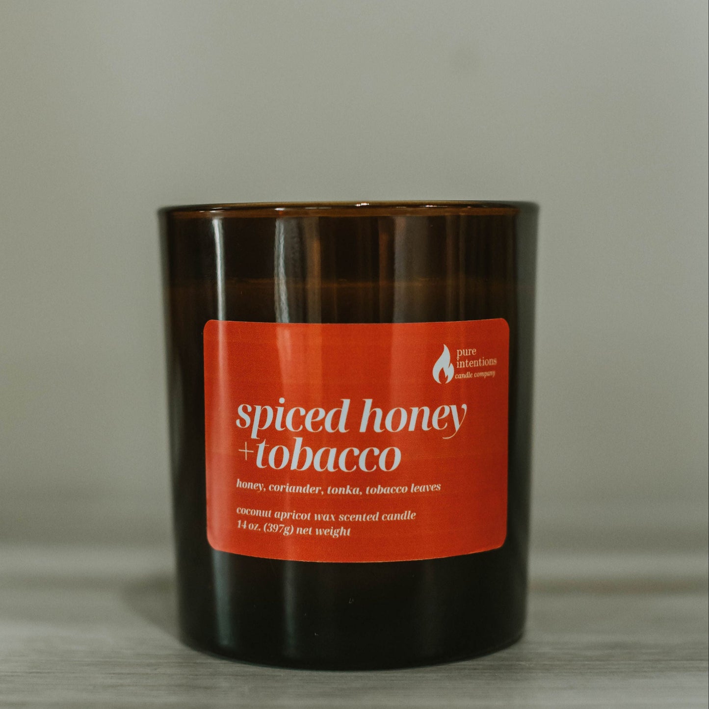 Candle with a red label on a neutral background