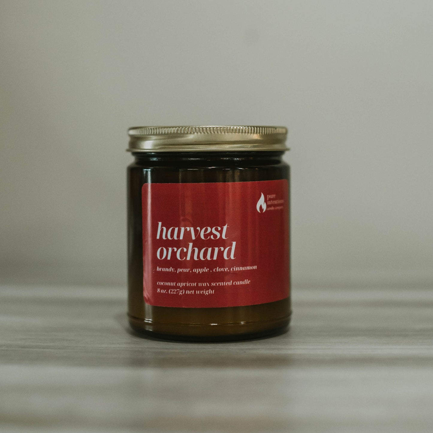 Jar of 'harvest orchard' candle on a neutral background