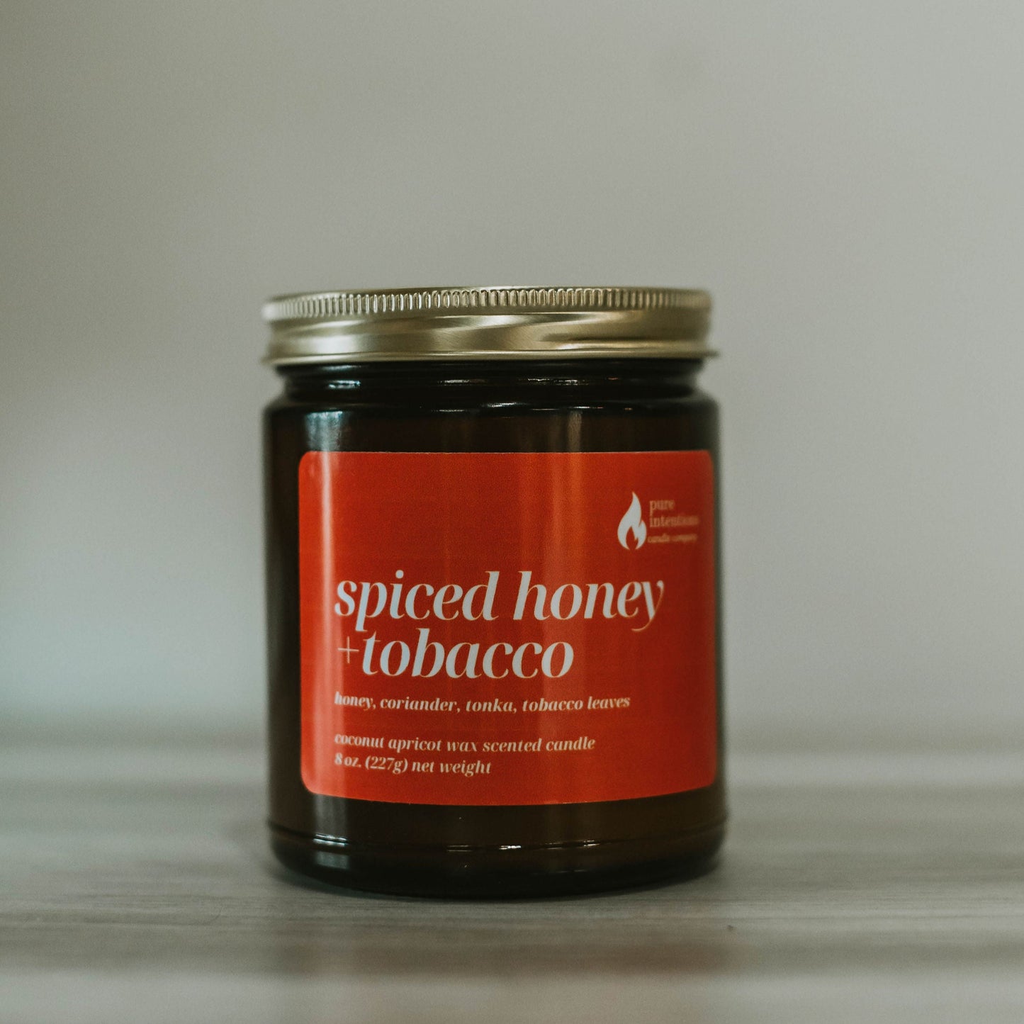 Jar of spiced honey tobacco on a neutral background