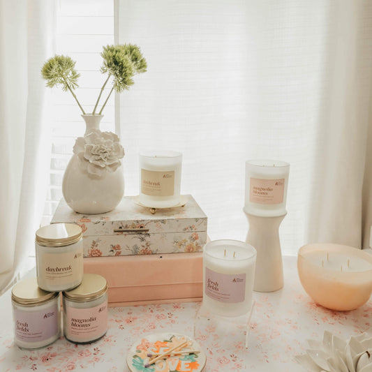 Collection of candles and decorative items on a table with a soft, blurred background