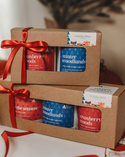 Set of candles in decorative boxes with ribbons on a neutral background