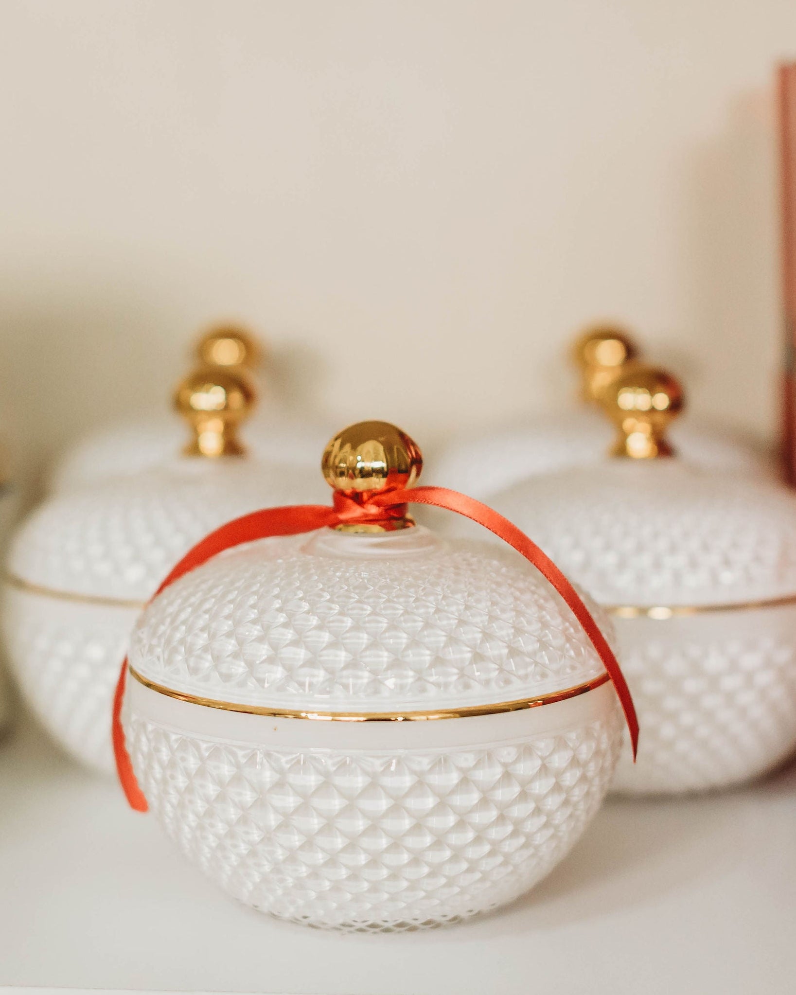 Assorted candles with 'Cranberry Woods' label on a shelf