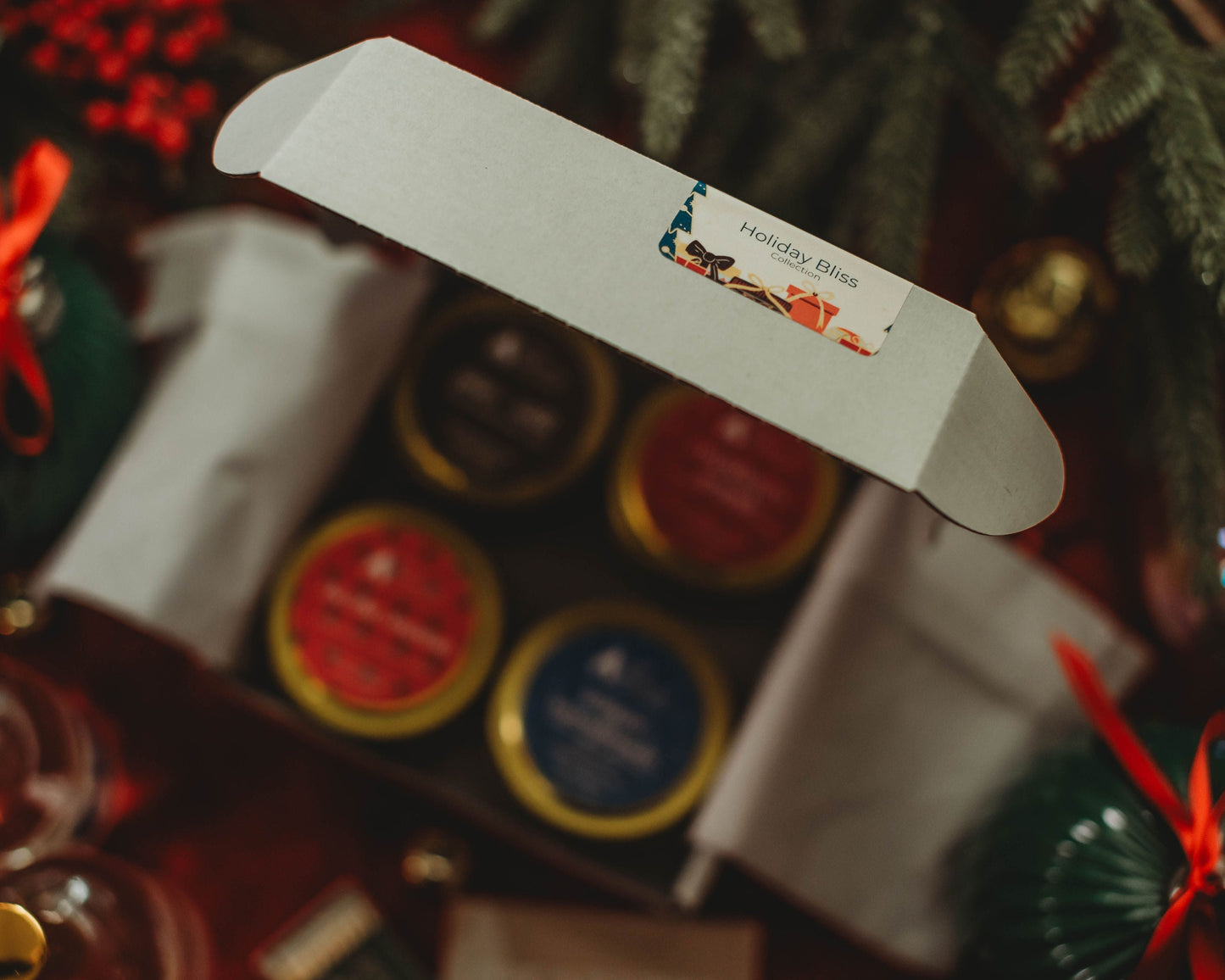 Close-up of a gift box with a decorative label against a blurred festive background.