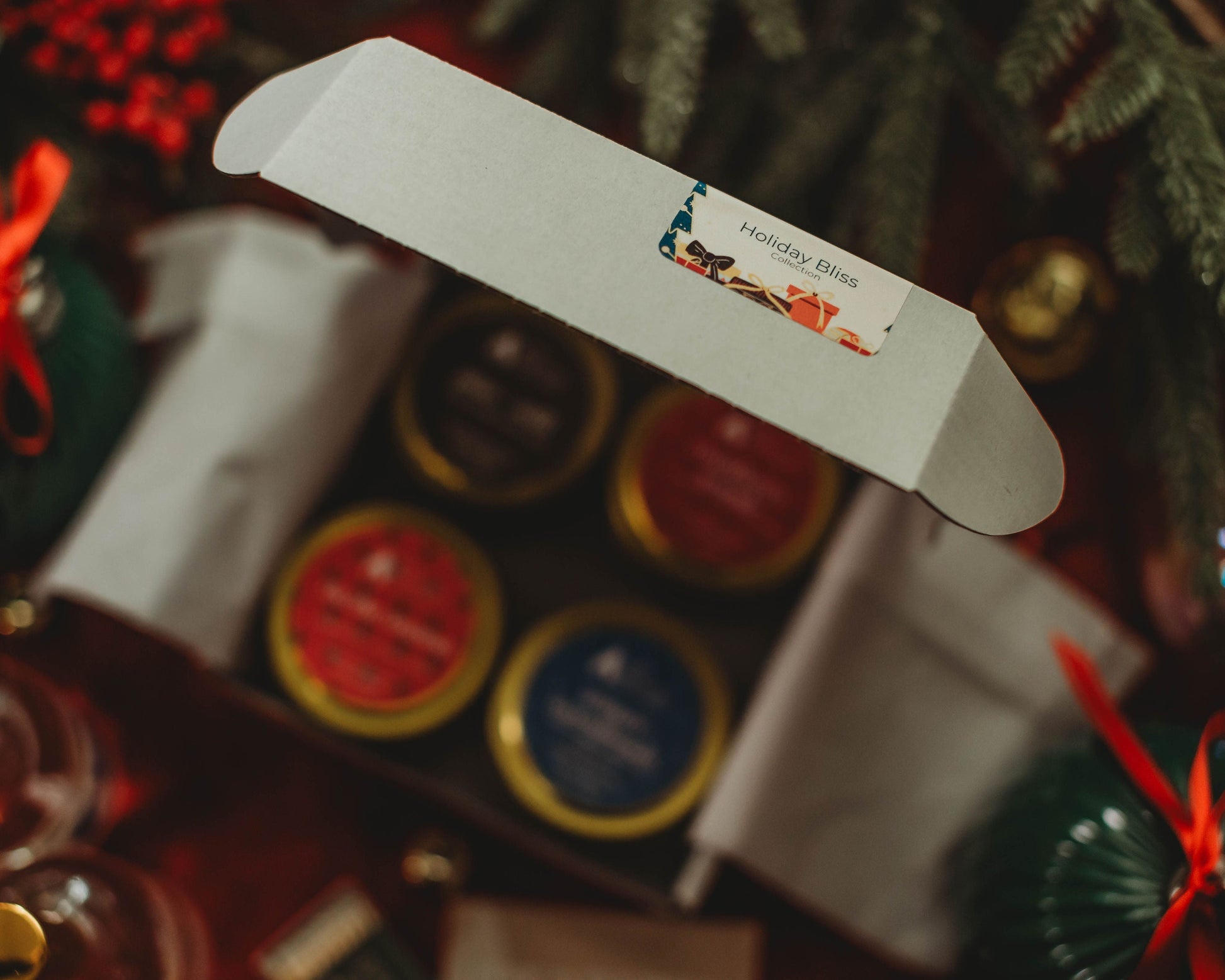 Close-up of a gift box with a decorative label against a blurred festive background.