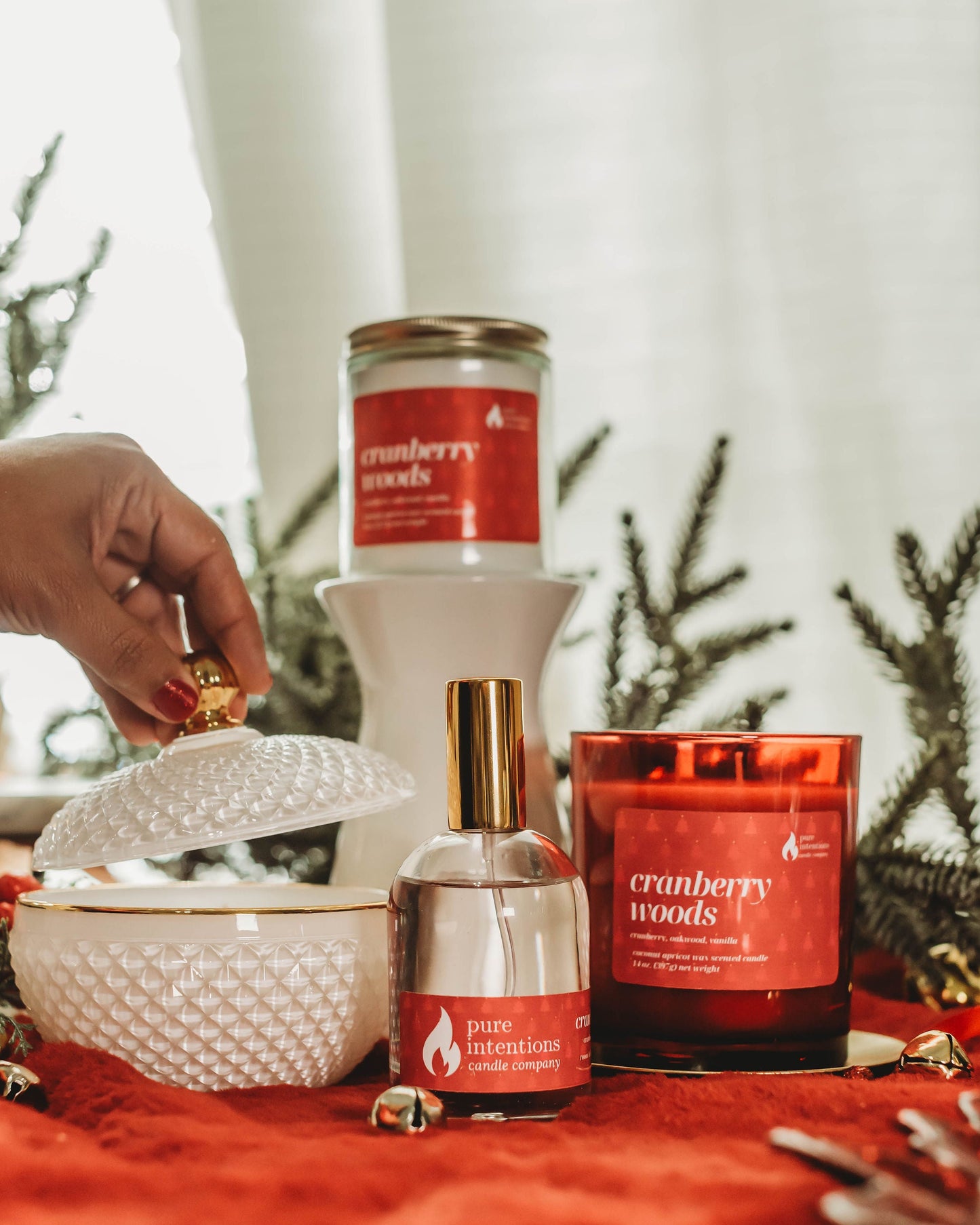 Candle and decorative items on a red surface with a blurred background