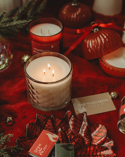 Candlelit scene with red ornaments and matches on a red surface