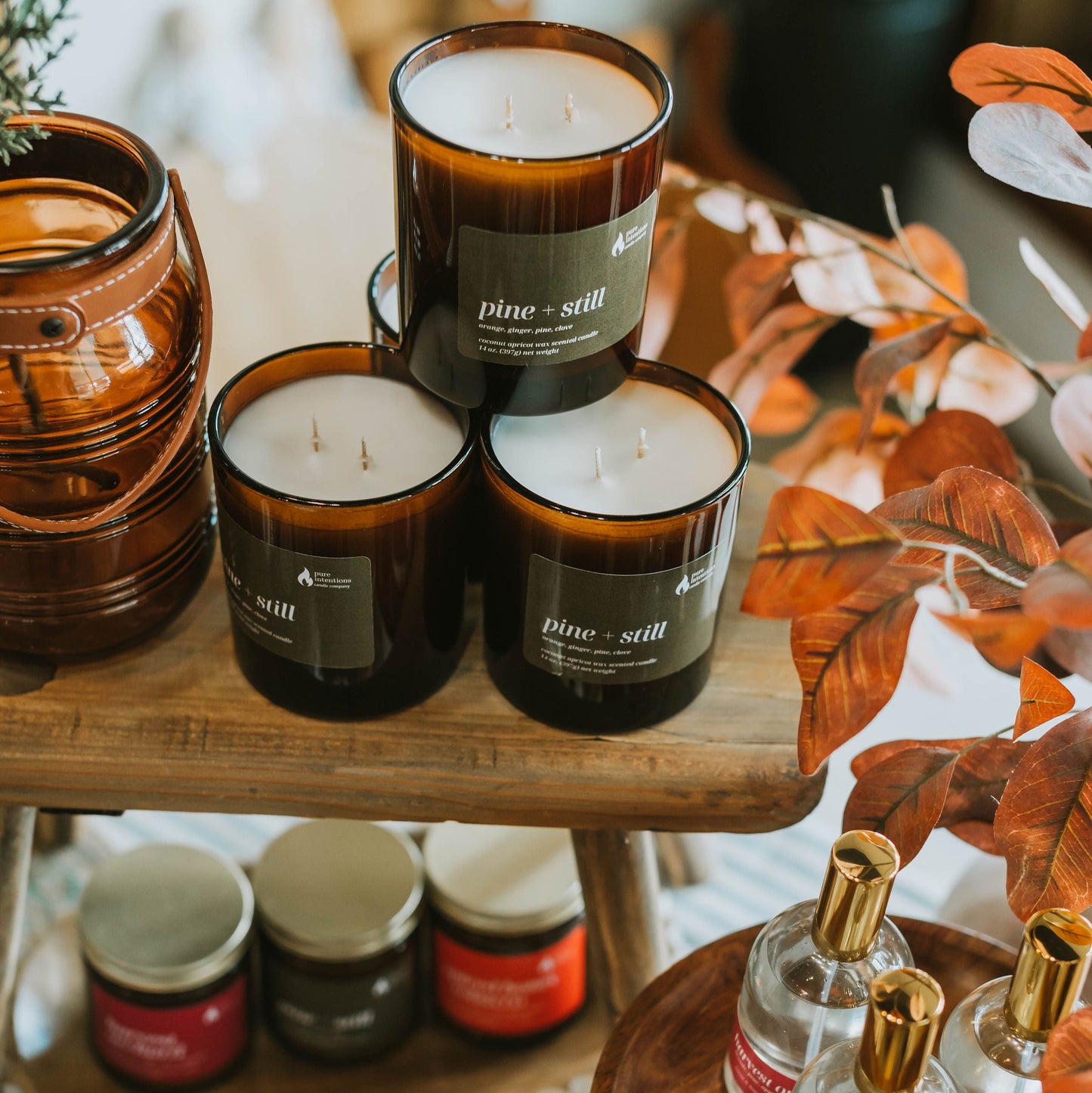 Candles and small containers on a wooden surface with decorative elements.