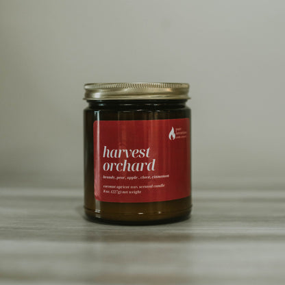 Jar of 'harvest orchard' candle on a neutral background